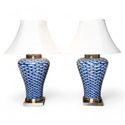 Pair of large lamps of tapering form, decorated in blue myriad fish pattern, on brushed ch...