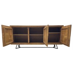 Samba 'Camden' oak sideboard, rectangular top over three block panelled cupboard doors, raised on angled black metal supports connected with stretcher