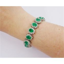 18ct white gold oval emerald and round brilliant cut diamond cluster bracelet, stamped 750, total emerald weight 14.70 carat, total diamond weight 7.24 carat