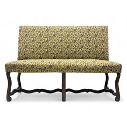 Early 20th century walnut framed bench, upholstered in floral tapestry fabric, raised on s...