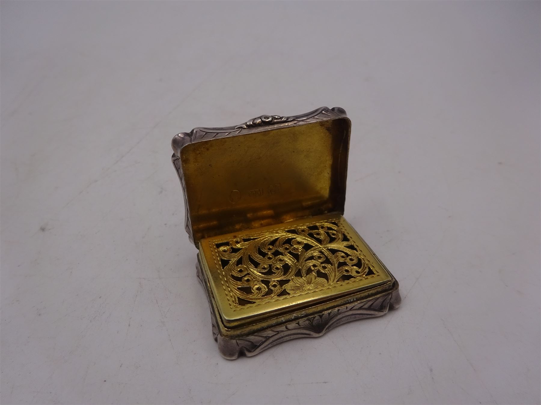 Victorian silver vinaigrette, with engraved name and scrolling decoration to hinged cover, the gilt interior with typical pierced cover, hallmarked Nathaniel Mills, Birmingham 1841, W3.7cm