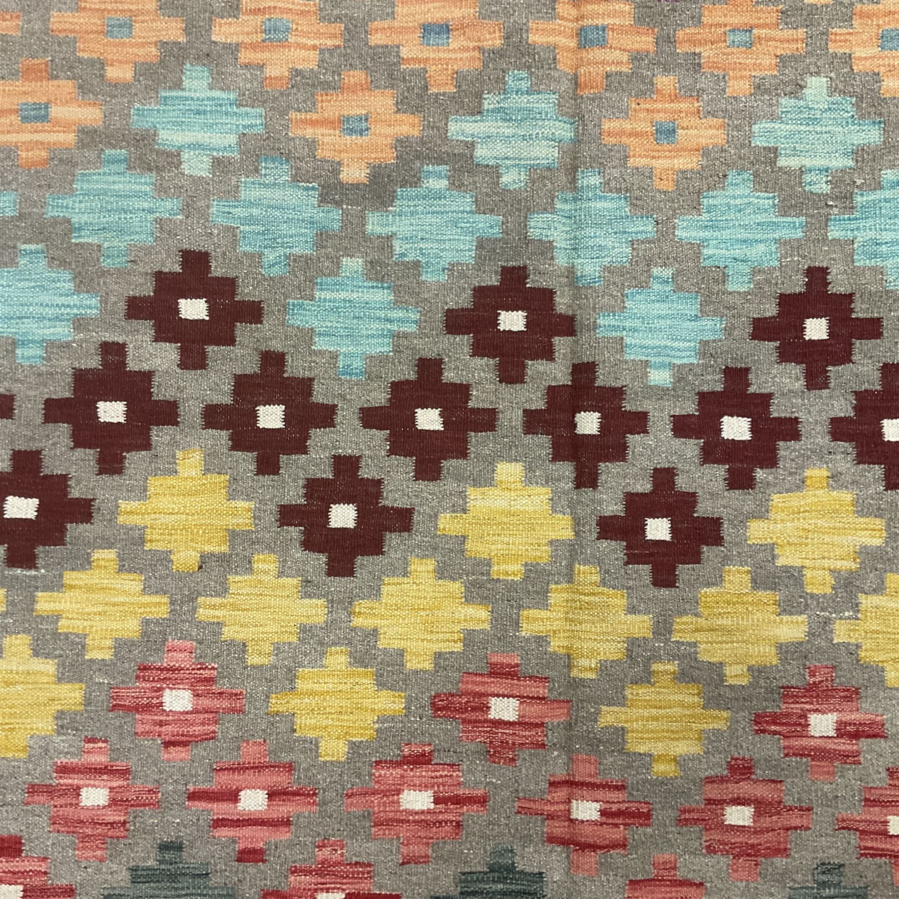 Anatolian Turkish kilim, light grey ground and decorated with multi-coloured geometric star motifs