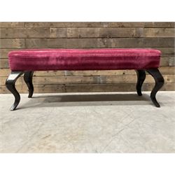 Large rectangular footstool upholstered in a maroon fabric with cabriole supports