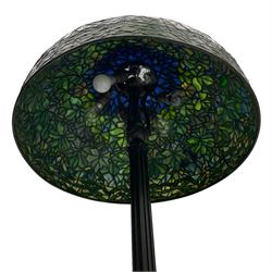 In the manner of Tiffany & Co. - bronze 'Chased Pod' design floor lamp, 'Maple Leaf' dome leaded glass shade decorated with flowers in blue and green shades, six branches on column decorated with stylised trailing stems terminating to circular base with stylised plant decoration, on scrolled feet, the base stamped 'Tiffany Studios New York 379' the inner shade stamped 'Tiffany Studios New York [...]'