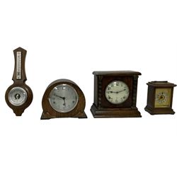 Assortment of three mantle clocks and an aneroid barometer.