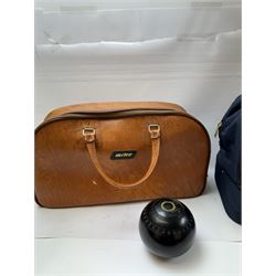 Two sets of flat green bowls, to include a ladies and gentlemans set, both contained within bowling bags