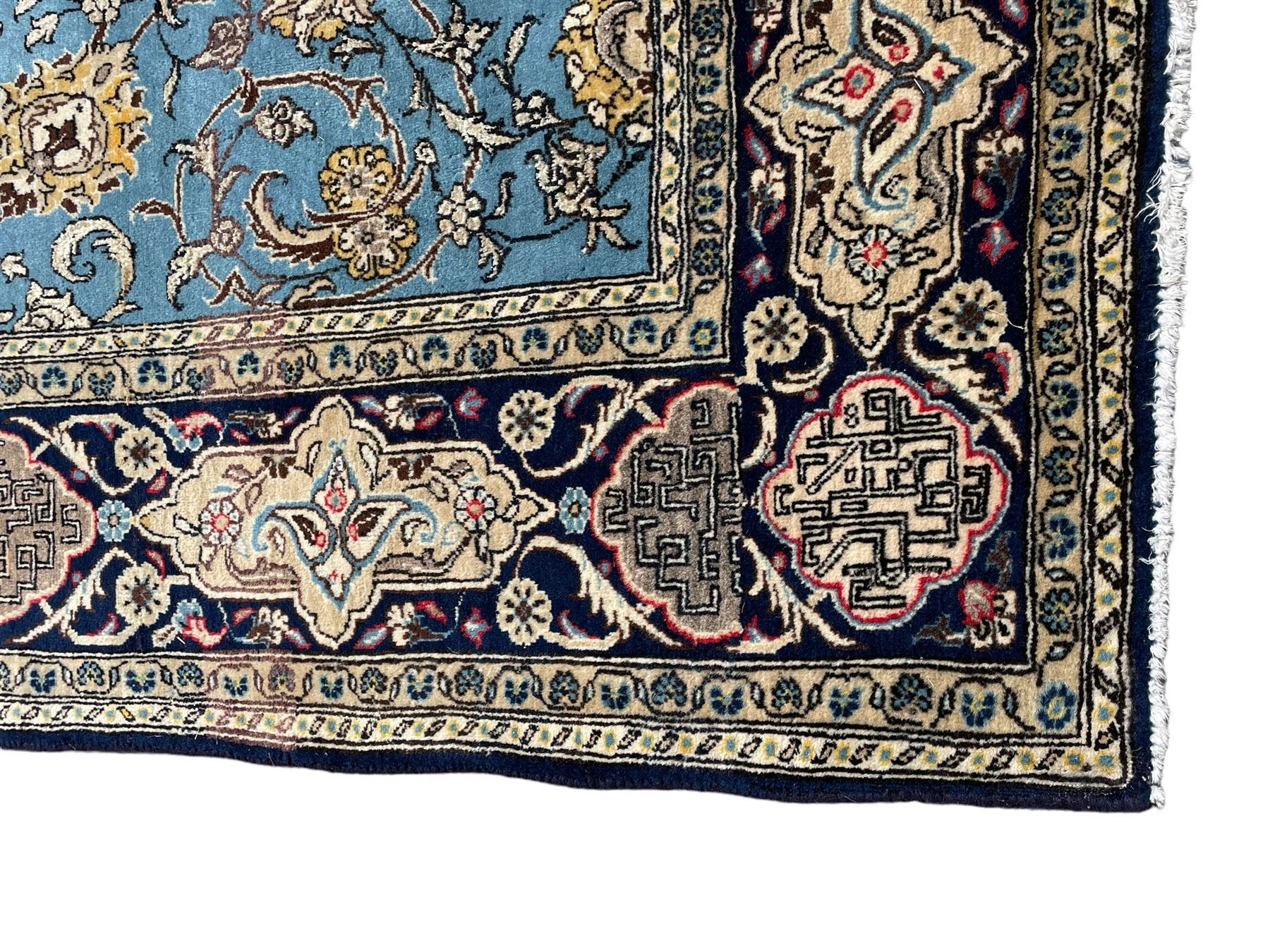 Persian Nain blue ground rug, overall arabesque design, the busy field decorated with interlacing branches and palmettes, indigo ground border with panels decorated with knots and lotus flower motifs, surrounded by trailing branches and flower heads, within guard stripes