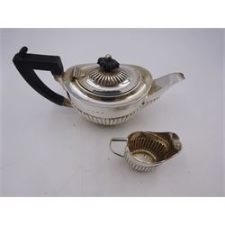 Edwardian silver bachelor's two piece tea set, comprising teapot and milk jug, each of oval part fluted form, the teapot black plastic handle and finial, hallmarked Synyer & Beddoes, Birmingham 1903, teapot H10.5cm