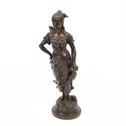 Bronze cast metal figure of a female cockle picker, upon a circular composite plinth, H39cm