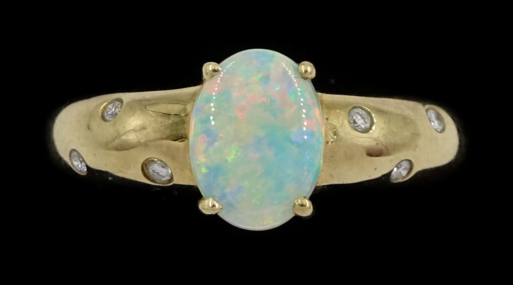 9ct gold opal ring, either side with three rubover set, round brilliant cut diamonds, Sheffield 2004