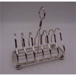 Victorian silver seven bar toast rack, each bar of trilobed form, with similar loop handle and upon four bun feet, hallmarked John Gilbert, Birmingham 1863, H16.5cm