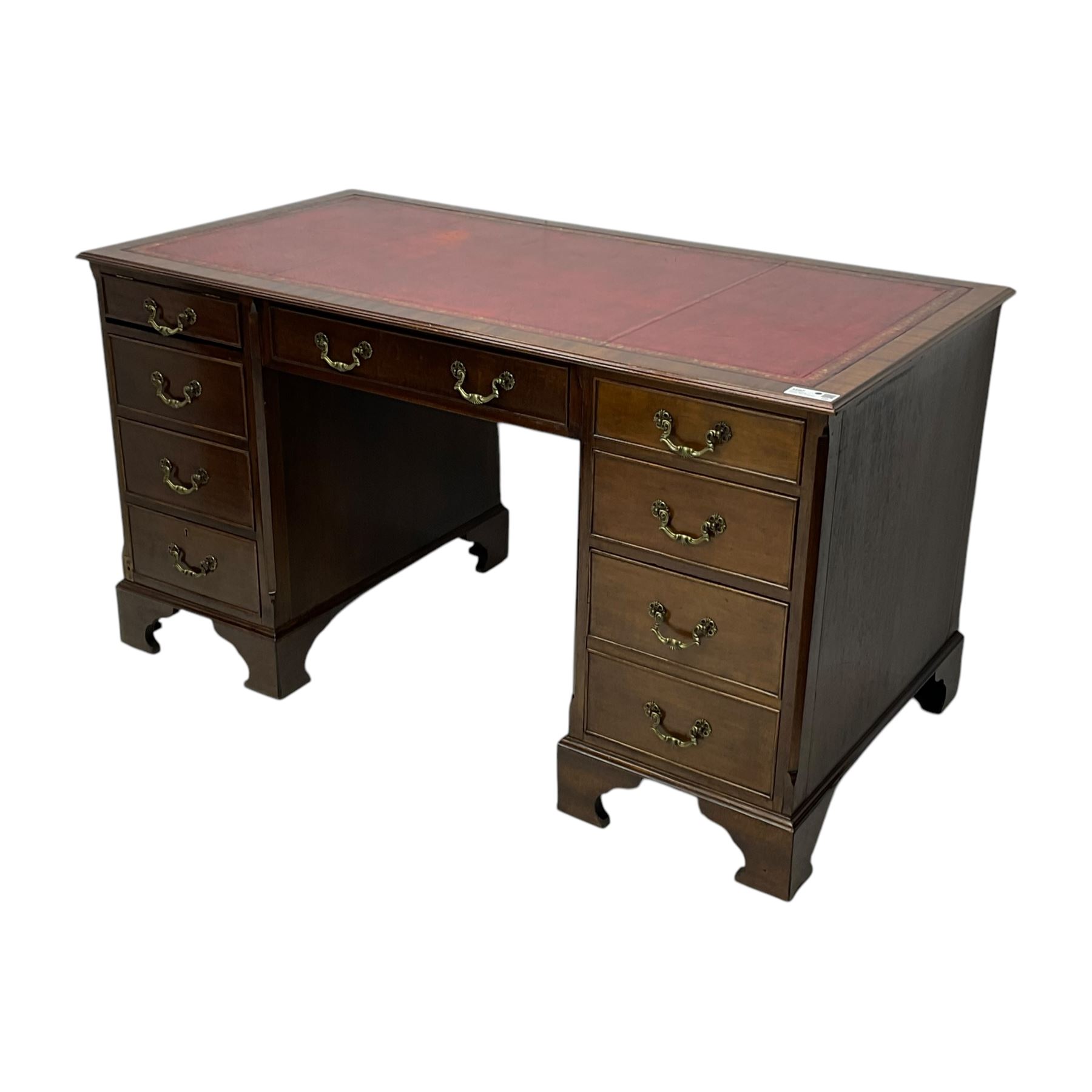 Georgian design mahogany twin pedestal desk, moulded rectangular top with red leather inset, fitted with seven drawers, on bracket feet 