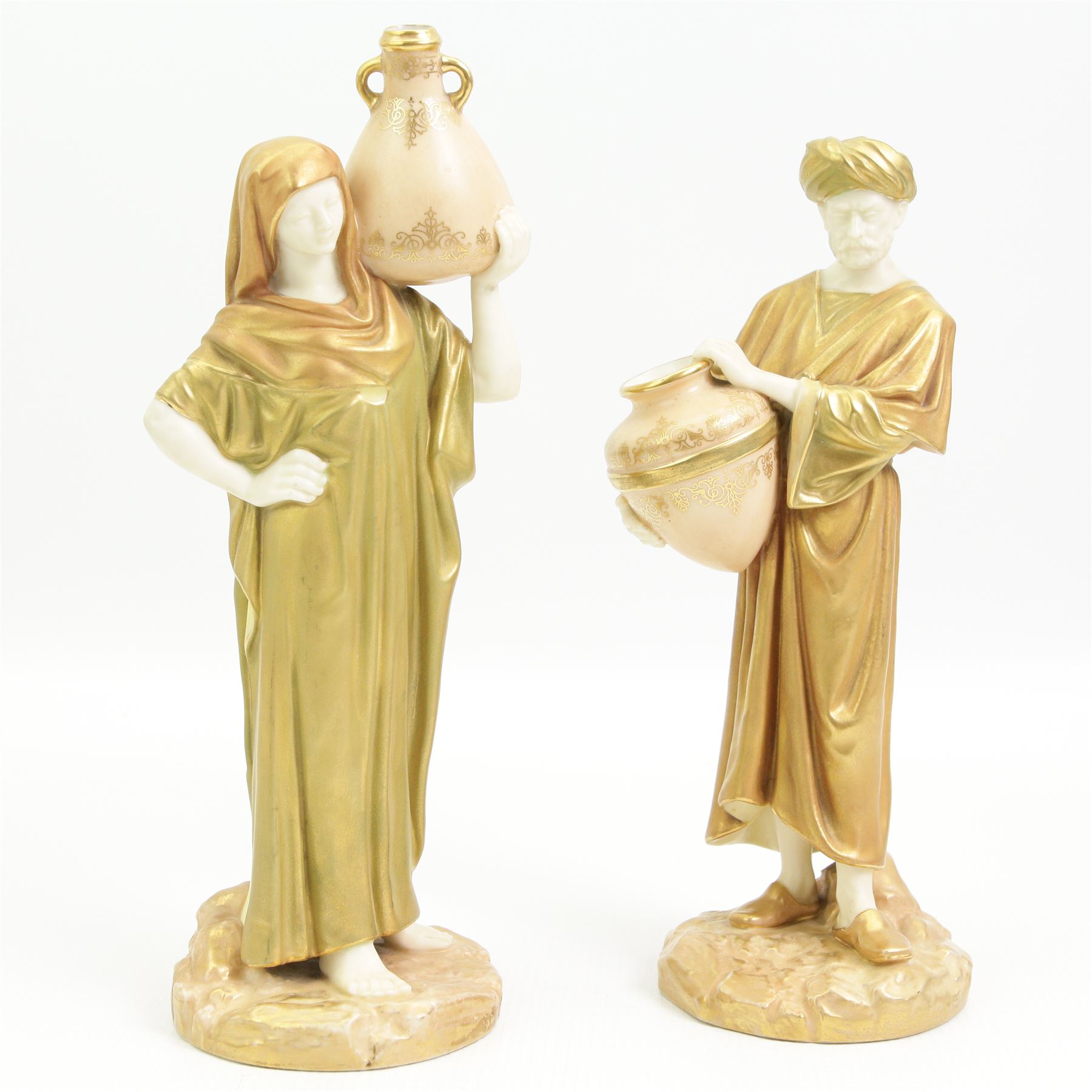 Pair of Royal Worcester figures of Egyptian water carriers after James Hadley dressed in gilt cloaks and on circular bases H24cm, number 1250, date code for 1913