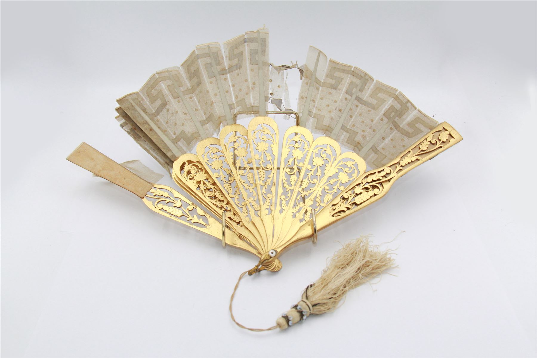 19th century carved gilt wood fan by Eugene Rimmel, the guards and sticks with pierced floral decoration, the chiffon leaf worked with sequins, with silk beaded tassel, stamped E.Rimmel 36 Strand London, with a purple silk lined box 