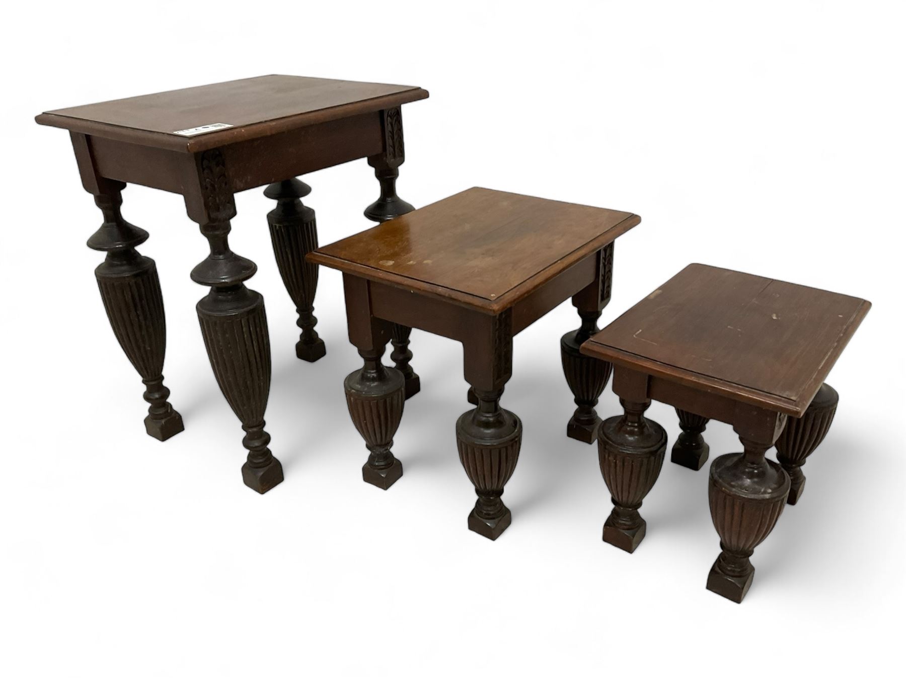 Late Victorian walnut nest of three tables, rectangular top with moulded edge, raised on reeded and turned urn shaped supports with acanthus leaf carving and square feet