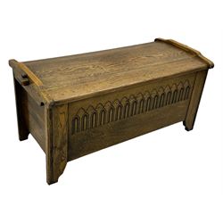 20th century oak coffer or blanket chest, rectangular hinged top over repeating Gothic arch carved front and shaped sides, constructed with pegged joints, on stile supports