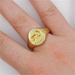 Mid 20th century 9ct gold intaglio signet ring, engraved 'strong' with lying dog above, London 1948