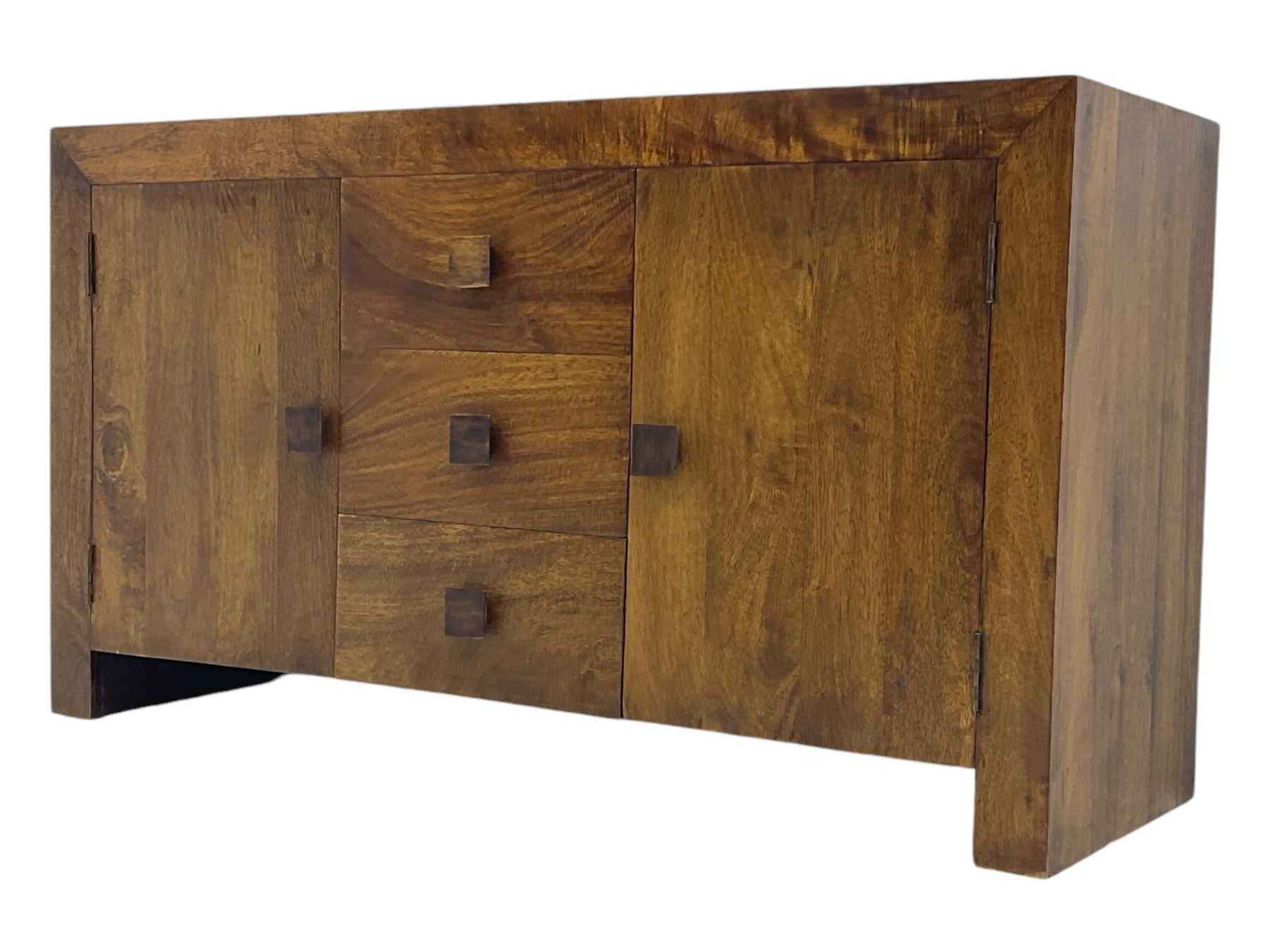 Contemporary Dakota mango wood sideboard, plain rectangular top over three central drawers flanked by cupboards with shelving, each with square pulls, raised on stile supports