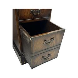 20th century mahogany twin pedestal desk, moulded rectangular top with red leather inset with gilt tooled border, central drawer over kneehole flanked by two banks of four graduating cockbeaded drawers, on plinth base