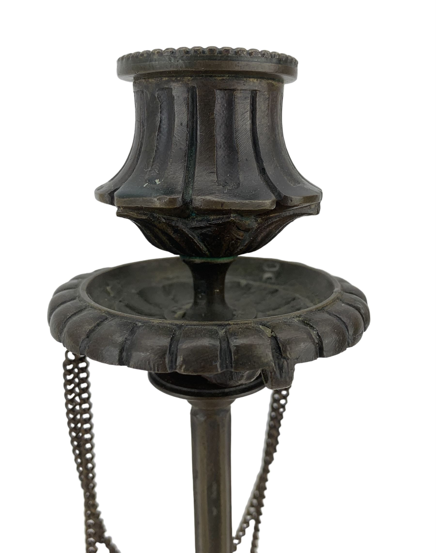 Pair of 19th century French patinated bronze candlesticks in the manner of Ferdinand Barbedienne, the gadrooned sconces hung with chains, reeded columns on tripod supports with hoof feet, H28cm 