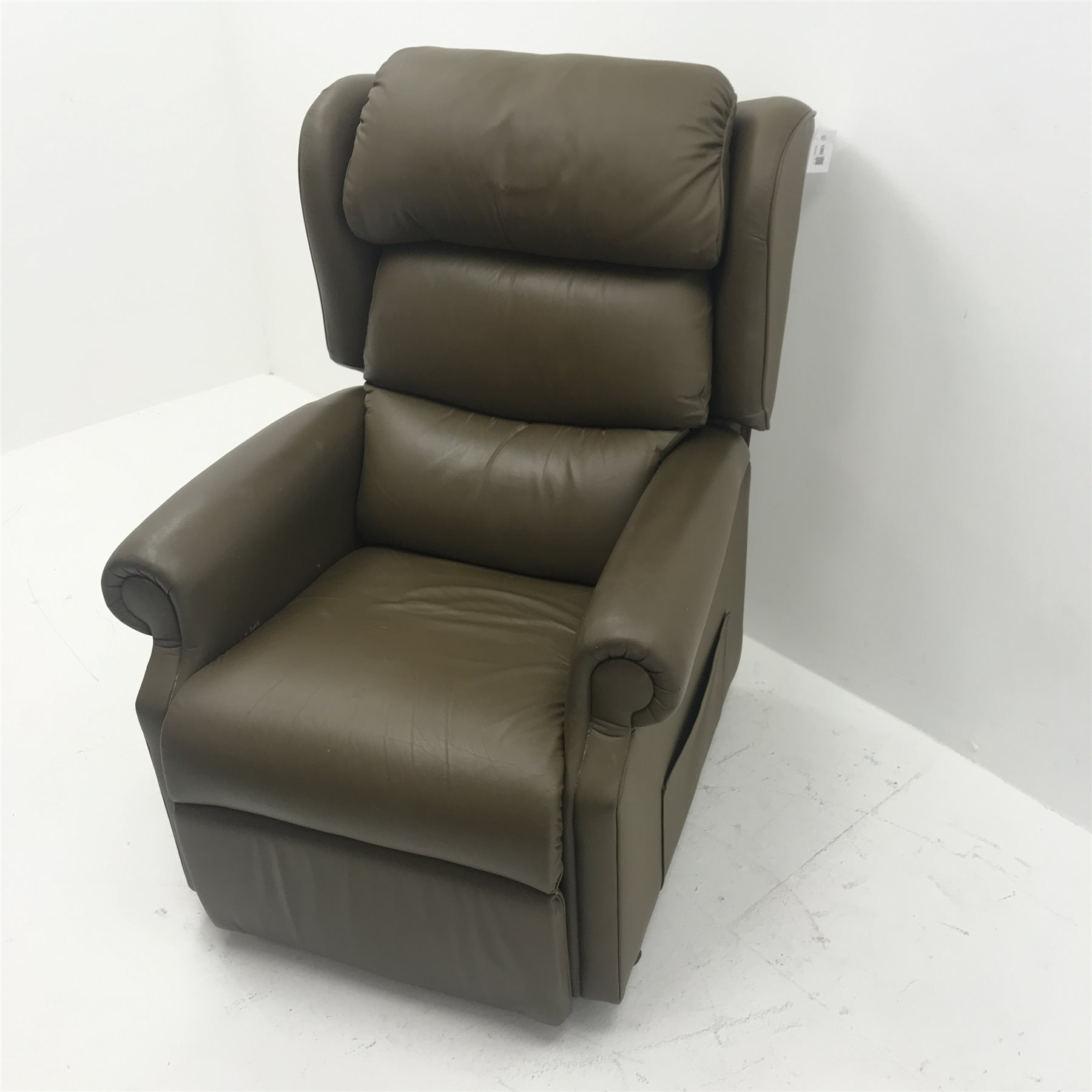 Electric reclining armchair upholstered in a green leather, W84cm