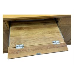 Contemporary light oak twin pedestal desk, fitted with three drawers over two cupboards with chrome handles, the central drawer with hinged front panel revealing pull-out keyboard tray, on plinth base