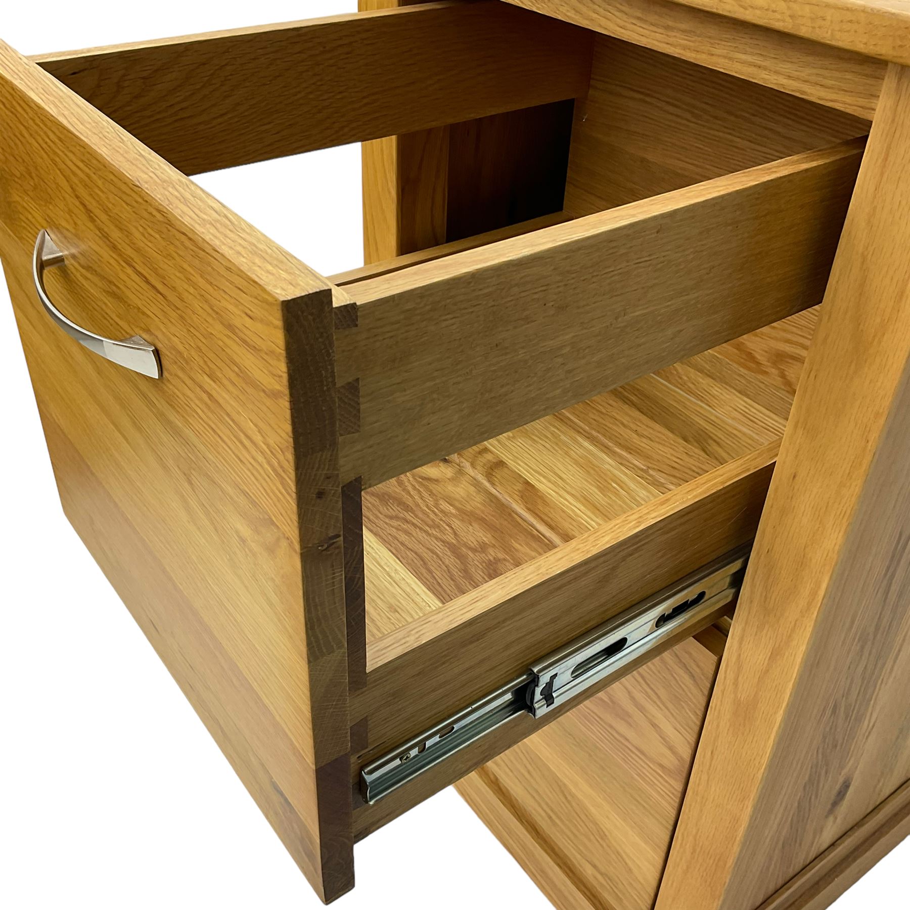 Contemporary light oak filing cabinet, rectangular top over two drawers each fitted with metal rods, on plinth base