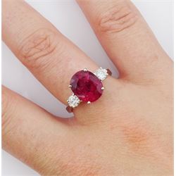 18ct white gold three stone oval cut ruby and round brilliant cut diamond ring, hallmarked, ruby approx 4.30 carat