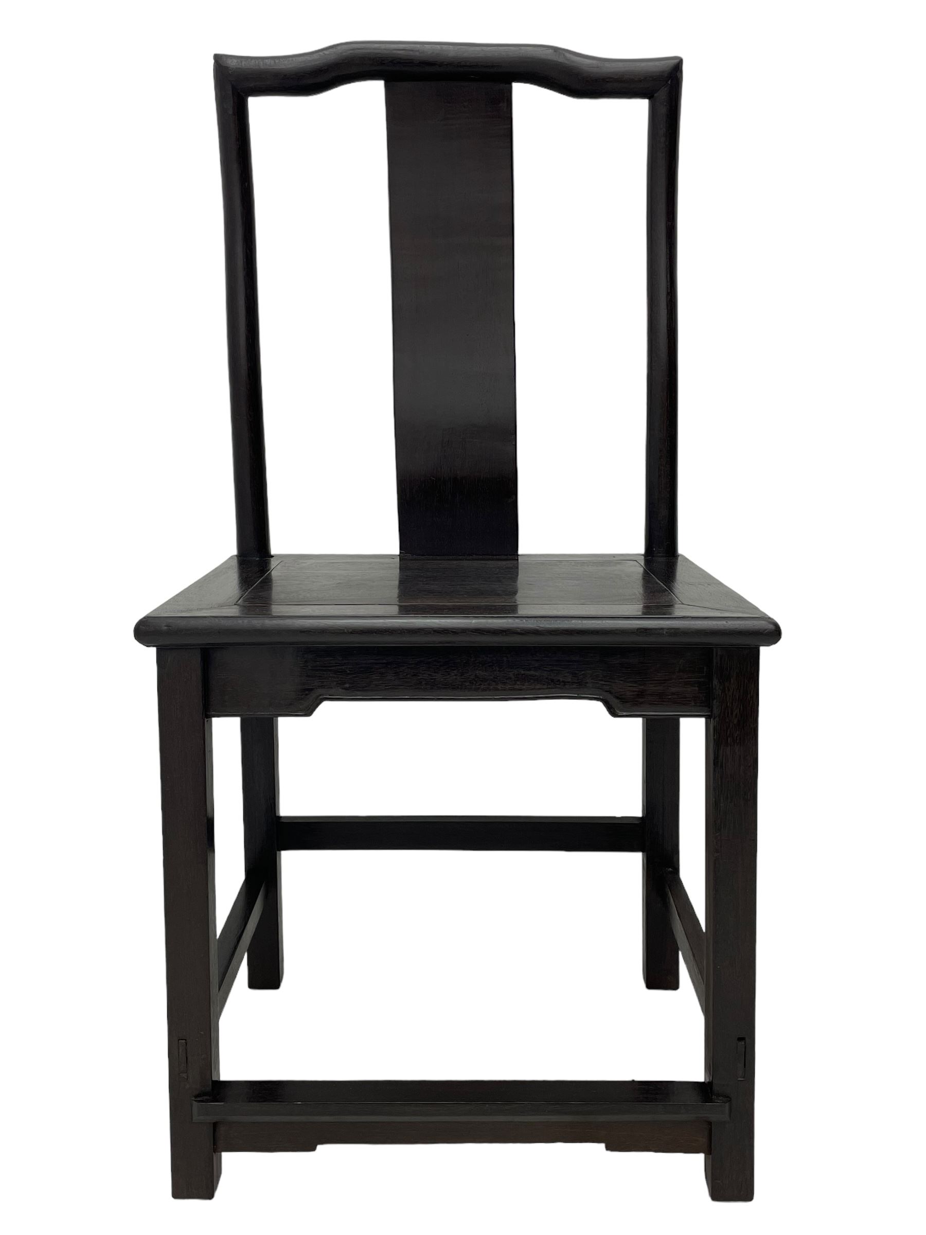 Pair of early 19th century Chinese Qing dynasty black wood side chairs, yoke cresting rail over shaped back panel, panelled rectangular seat on square supports united by stretchers 