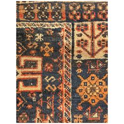 Persian Hamadan red and indigo ground rug, the central pole medallion decorated with geometric motifs, guarded border decorated with stylised plant motifs 