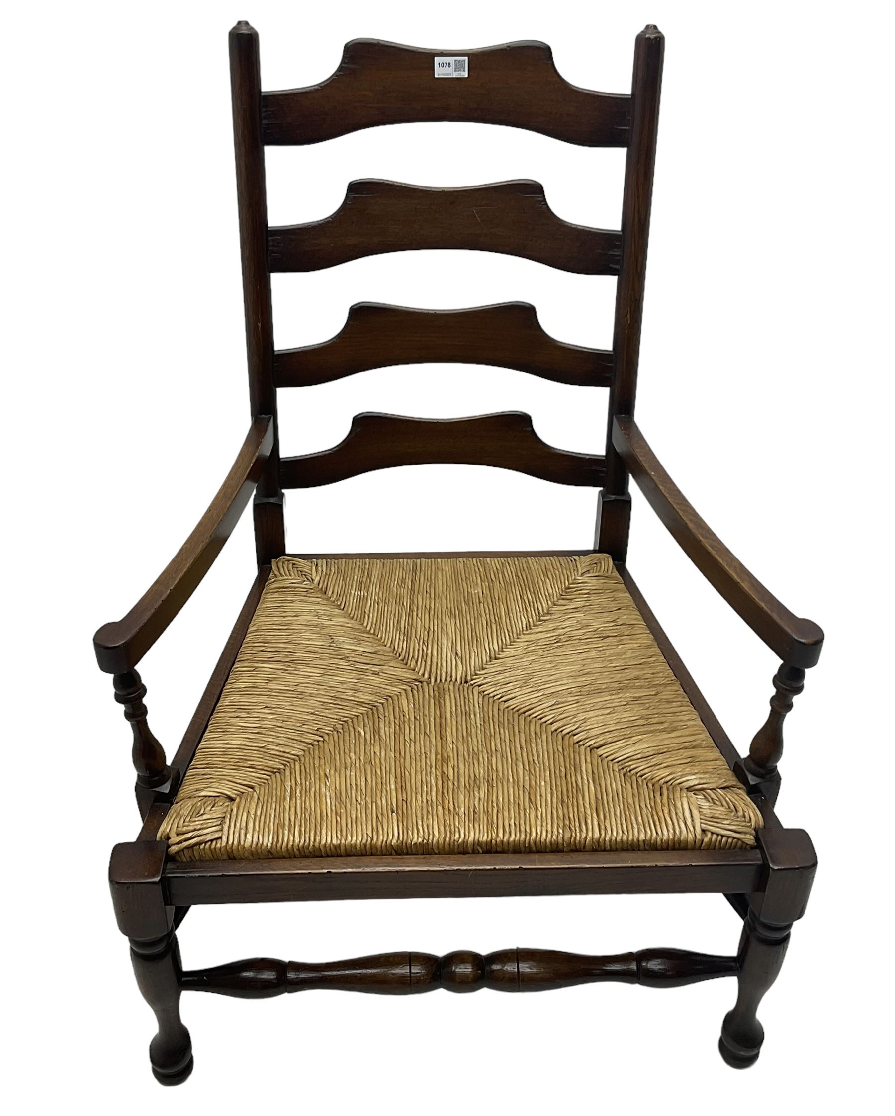 Georgian design oak country low armchair, waived ladder back over rush seat, raised on turned  supports united by stretchers; together with matching stool