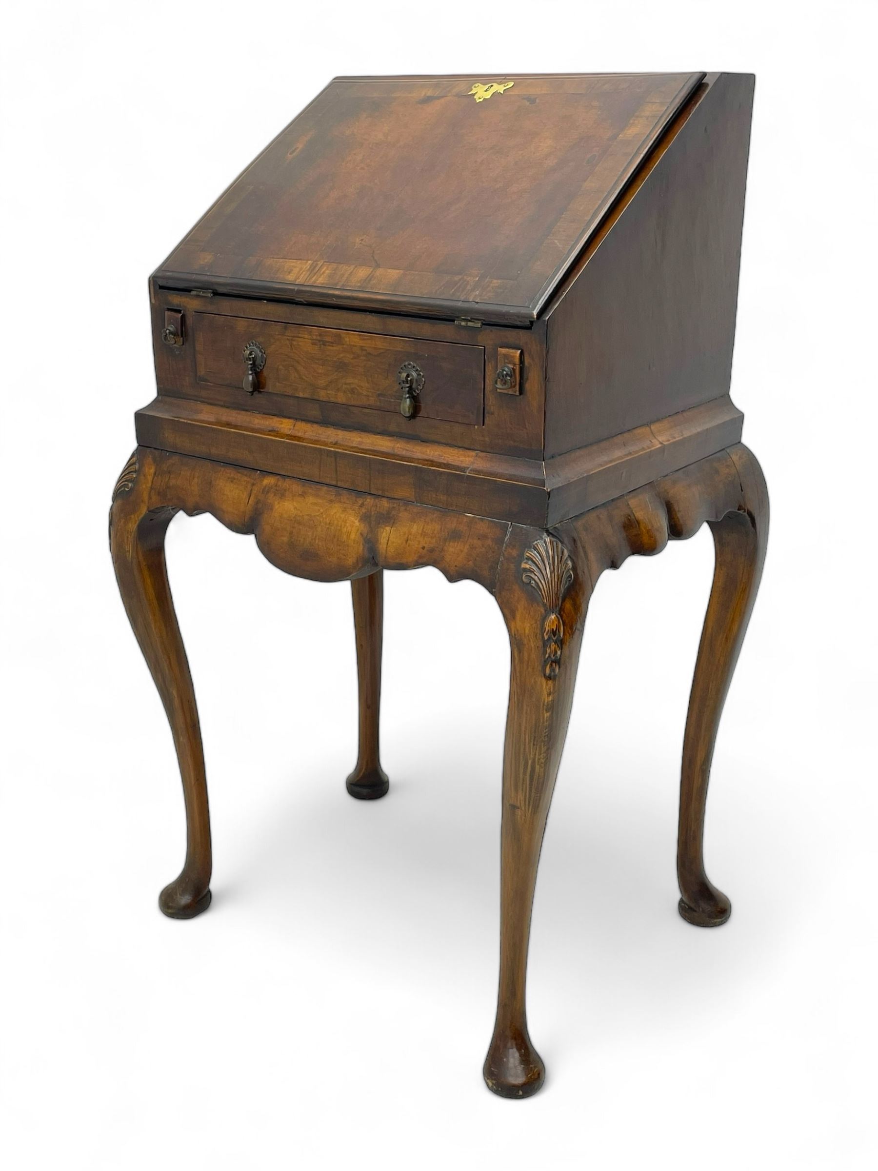 20th century walnut bureau, hinged fall front with moulded edge and cross banding over single drawer, the interior fitted with six pigeonholes and three drawers, on shell and bell flower carved cabriole supports, scalloped apron and side rails 