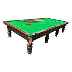 Riley - early 20th century full-sized mahogany billiards or snooker table, on eight turned baluster supports, with cue rack, scoreboard, balls and various cues 