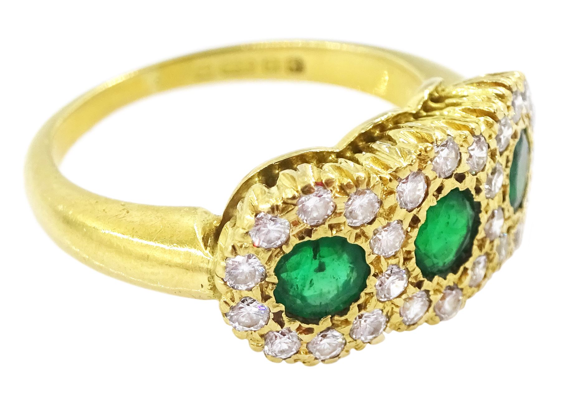 18ct gold emerald and diamond cluster ring, three round cut emeralds, with round brilliant cut diamond surround, London 1976