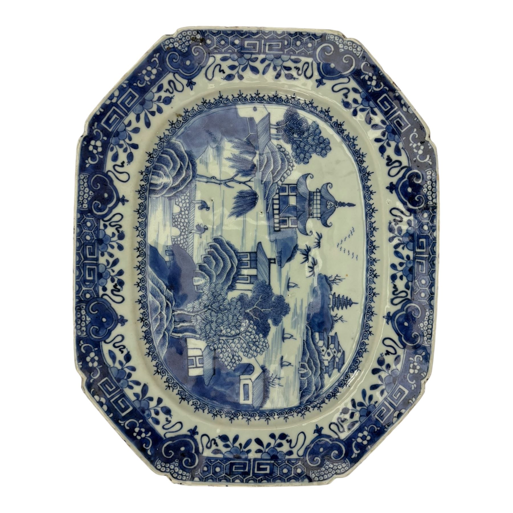 Six 18th century Chinese Export blue and white platters, each of rectangular canted form decorated with various landscape scenes, within foliate borders, max L45cm (6)