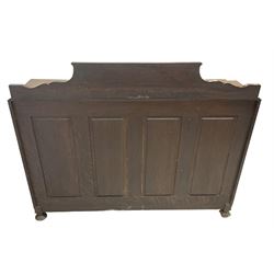 Early 20th century heavily carved oak bookcase bureau, raised back with grape-vine carved frieze, over fall-front enclosing fitted interior, above two short drawers and curved frieze drawer, flanked by astragal glazed and panelled cupboards, on turned feet