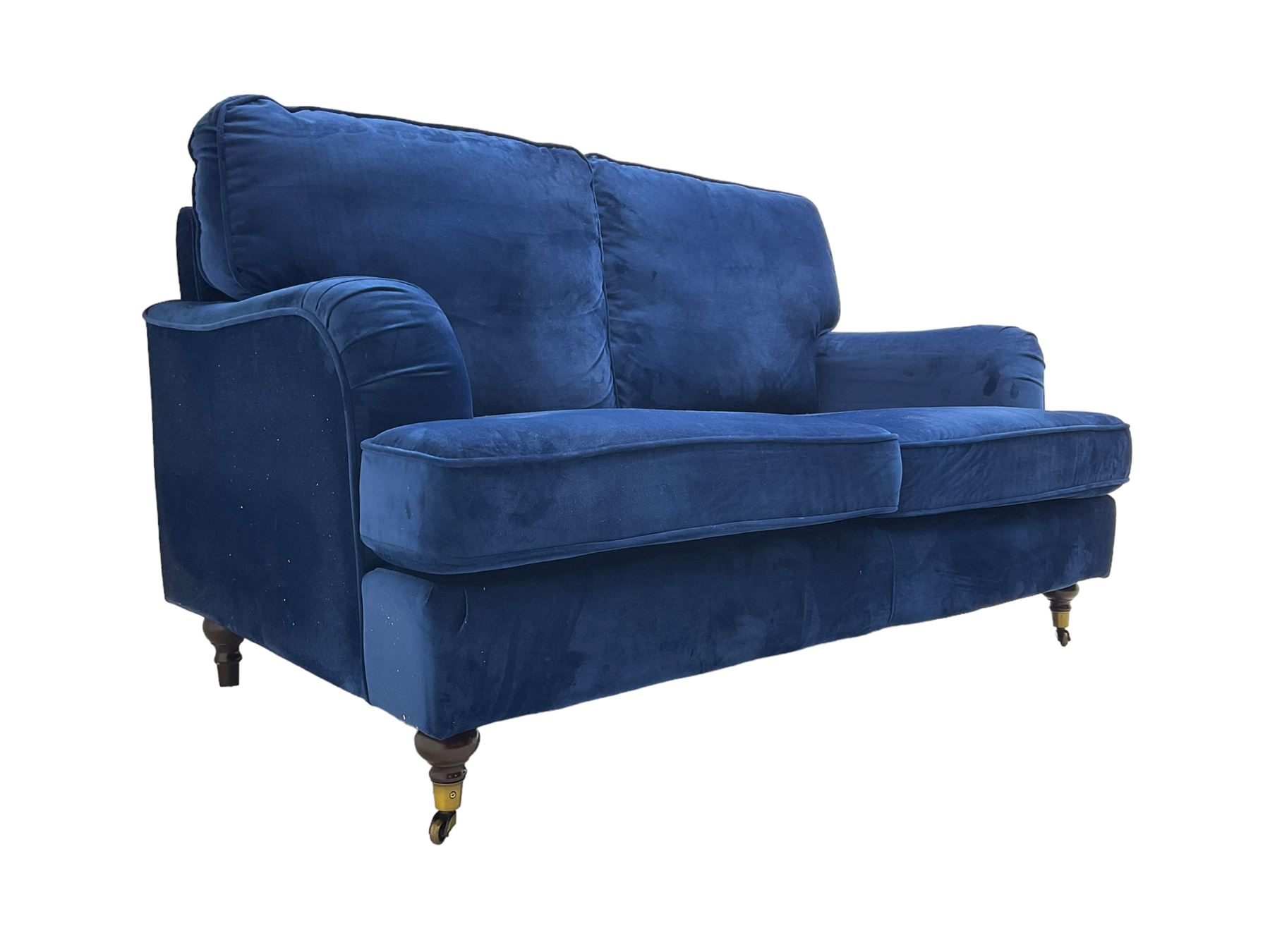 Howard design - two-seat sofa upholstered in blue fabric, traditional shape with rolled arms, on walnut finish turned feet with brushed metal cups and castors