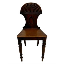 Regency mahogany hall chair, the carved back with shell motif and oval medallion, supported by turned front legs and splayed rear legs