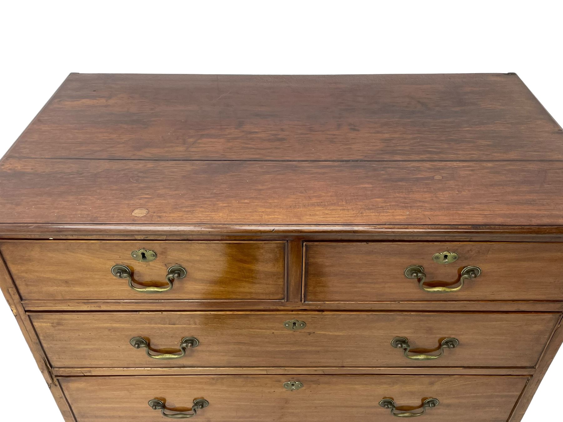 George III mahogany chest, moulded rectangular top over two short and three long cock-beaded drawers, fitted with brass swan neck handles and circular plates, on bracket feet