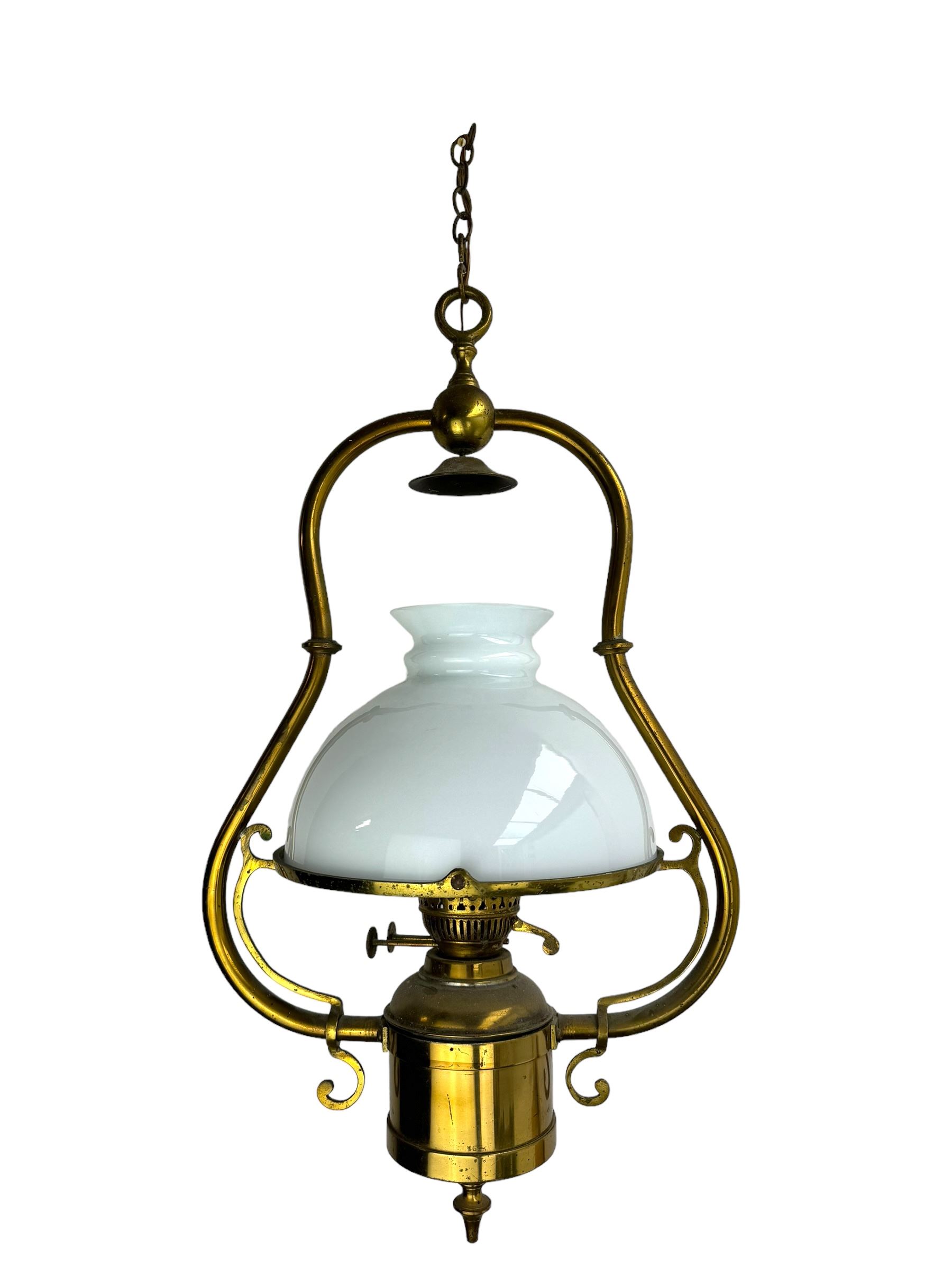 Set three brass framed light fittings, one with white glass shade, converted to electricity, H64cm