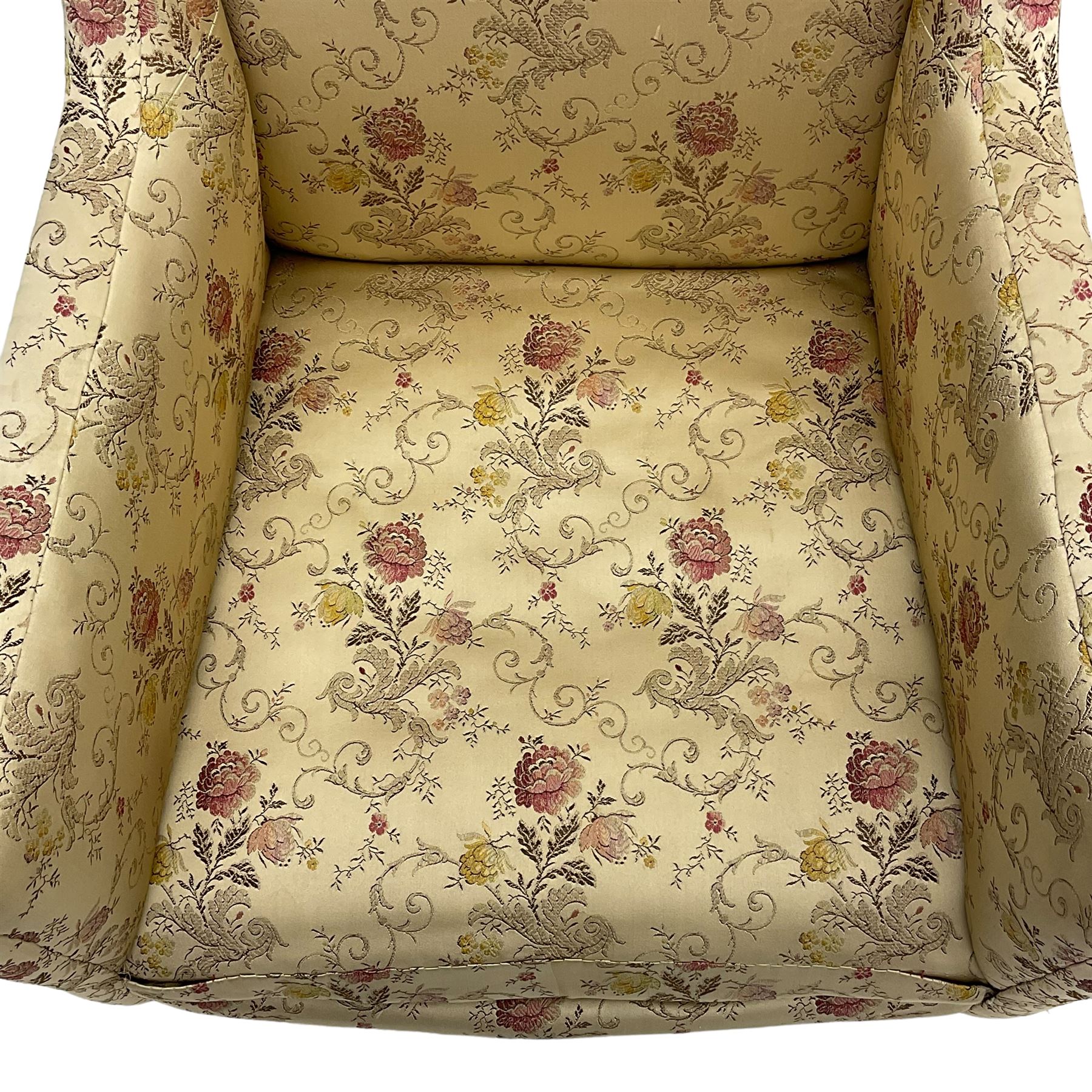 Edwardian hardwood-framed armchair, upholstered in floral pattern fabric, on square tapering front supports, brass and ceramic castors 