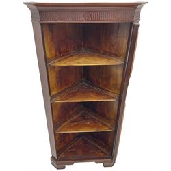 19th century mahogany floor-standing corner display cabinet, moulded cornice over blind fretwork frieze, enclosed by single astragal glazed door, the interior fitted with three shelves, on bracket feet