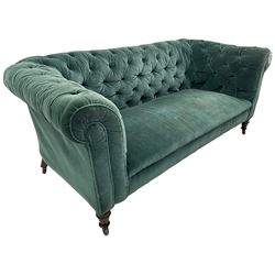 Victorian hardwood-framed Chesterfield sofa, traditional shape with low back and rolled arms, upholstered in teal buttoned fabric, on turned front feet with brass and ceramic castors 