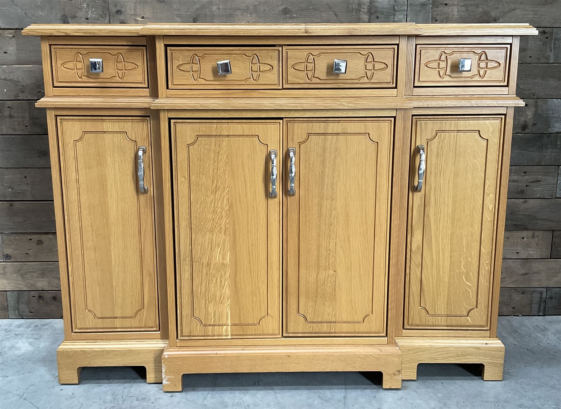 Light oak breakfront sideboard dresser, fitted with four drawers and four cupboards