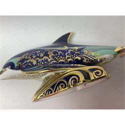 Three Royal Crown Derby paperweights, comprising Bottlenose Dolphin, Baby Bottlenose Dolphin and Striped Dolphin, all with gold stoppers 