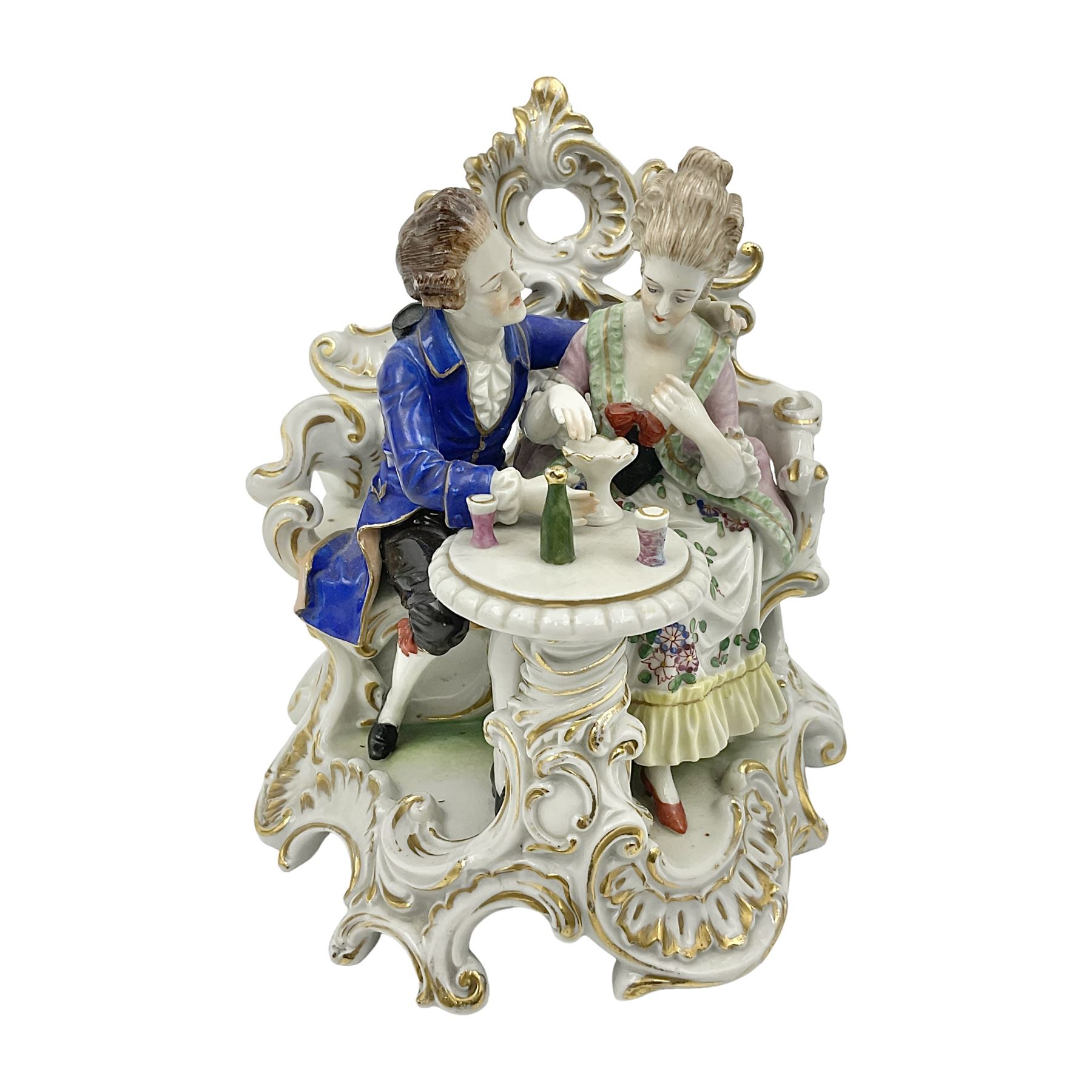 Figure group, probably Volkstedt, modelled as a courting couple seated before a table, the ornate bench and table conforming with and leading from the gilt heightened scrolling base, with blue painted mark beneath, H14.5cm
