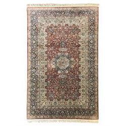 Persian silk finely knotted rug, central floral rosette medallion surrounded by curling br...