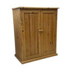 Pine cupboard, rectangular moulded top over two panelled doors enclosing two plank shelves, on plinth base