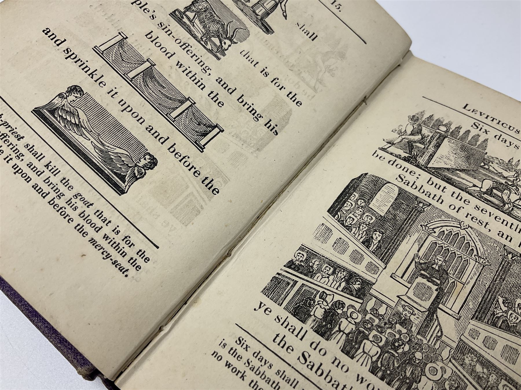 Early 20th century Hieroglyphic Bible or Select Passages from the Old and New Testament Represented by Emblematical Figures For The Amusement and Instruction of Youth, pub. Houlston and Sons, London, together with a wooden crucifix with metal banding and details, including skull and crossbones motif, and one other crucifix