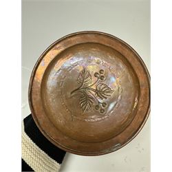 Middle eastern copper bucket, with chased and embossed band of animal decoration, together with a copper jardinière embossed with floral panels, copper plate with embossed leaf motif and two brass helmet shaped coal scuttles, bucket H26cm